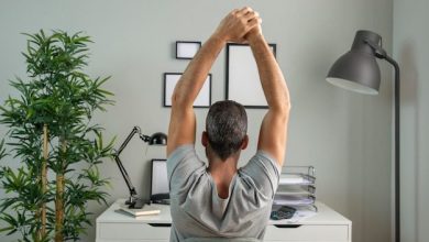 back-view-man-desk-stretching-while-working-from-home_23-2148806668-7056186