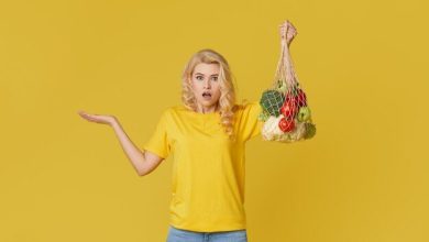 surprised-woman-hold-string-bag-full-organic-vegetables-yellow-wall_192729-668-8571457